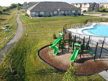 a yard with a playground and a swimming pool