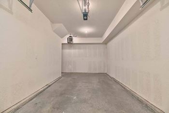 an empty room with a concrete floor and white walls