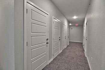 a row of white doors in a hallway