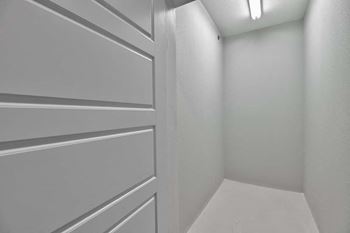 an empty white hallway with a white closet