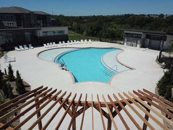 a large swimming pool with chairs around it