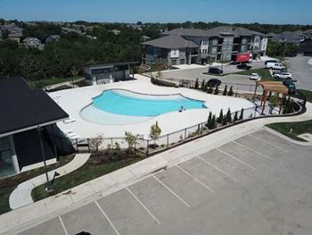 an aerial view of a swimming pool in a parking lot