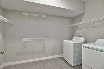 a laundry room with a washer and dryer and a sink