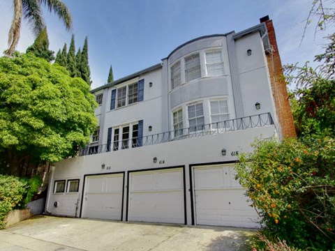a white house with a garage door in front of it