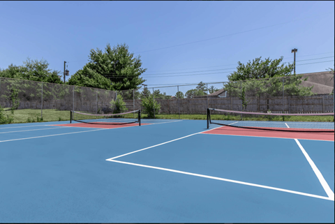 A tennis court with a net and two nets.