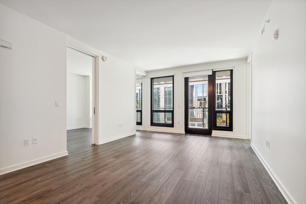 A room with a wooden floor and a glass door.
