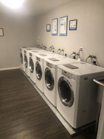 a row of washing machines in a laundry room