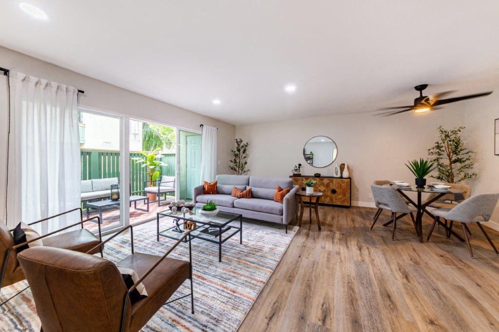 a living room with a couch and chairs and a table
