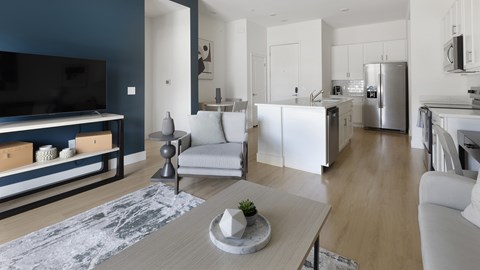 A modern living room with a television, a sofa, and a coffee table.