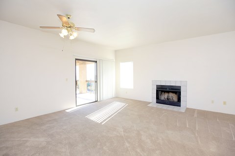 A modern living room with a white sofa and a round ottoman.