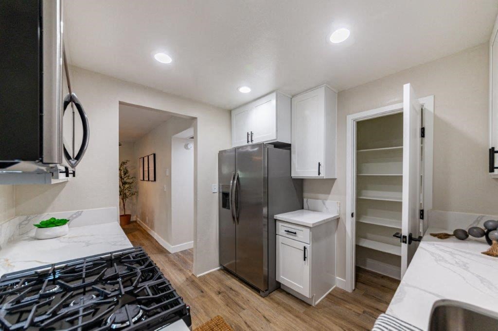 a kitchen with a stainless steel refrigerator and a counter top