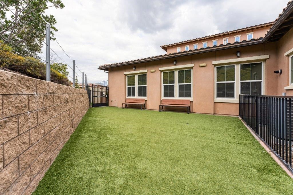 a house with a green yard and a fence