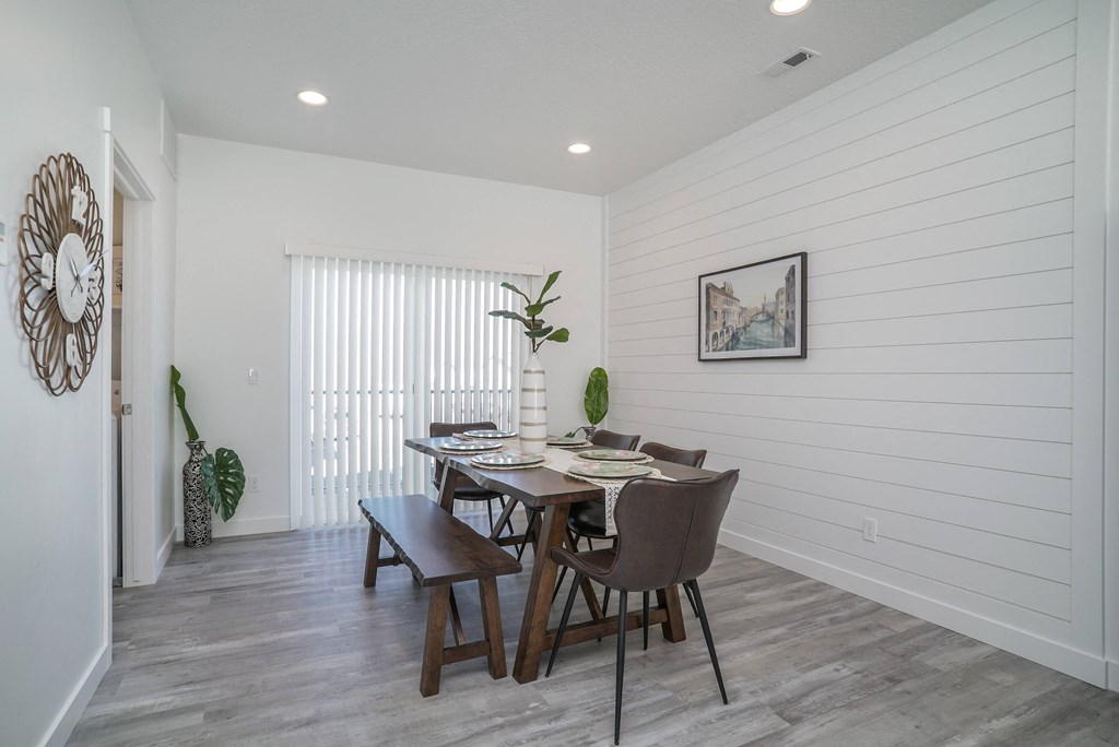a dining room with a table and chairs