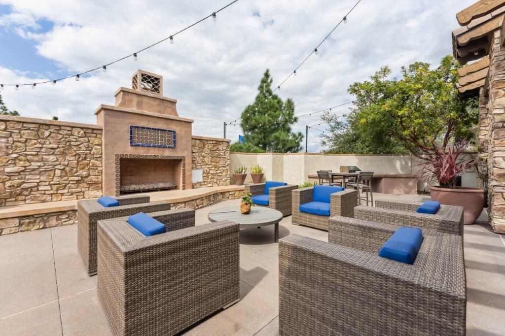 the patio has a fireplace and seating areas