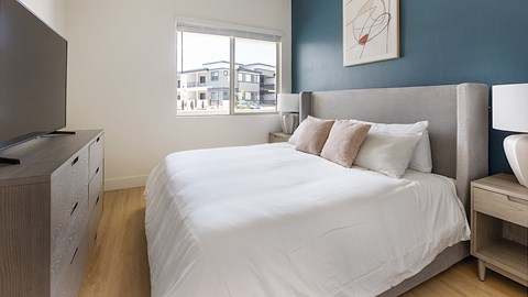 A bedroom with a large bed and a television.