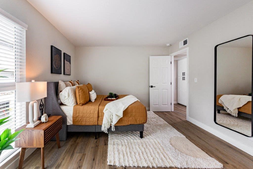 a bedroom with a bed and a mirror