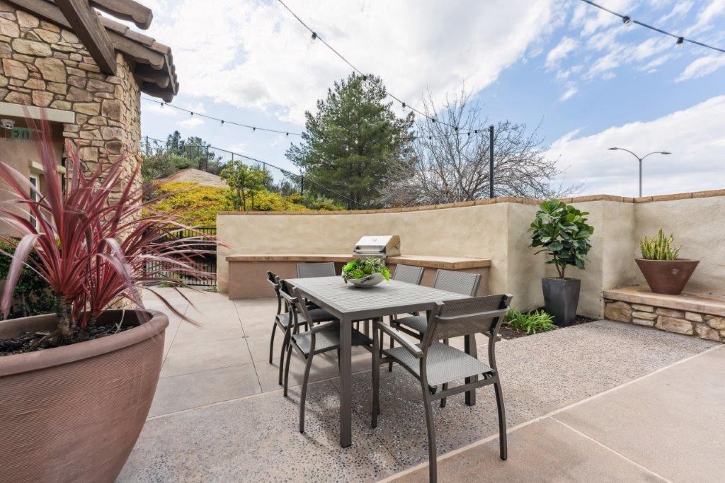 a patio with a table and chairs on it