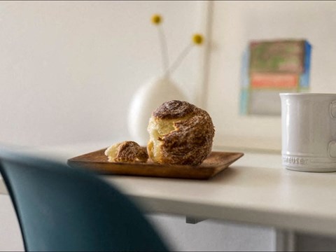 a plate with a muffin and a cup of coffee on a table