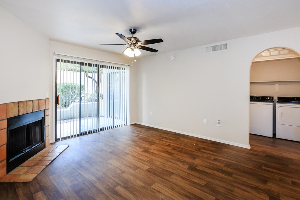 A room with a fireplace and a ceiling fan.