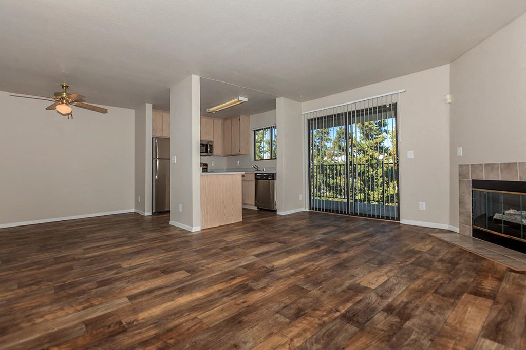 Sagecliff  living room with a fireplace and a kitchen in the background