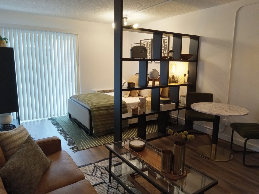 a living room with a couch and a table and a bed