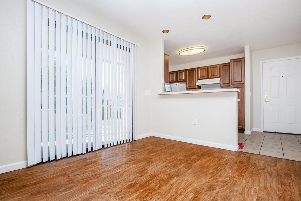 A room with wooden floors and white walls.