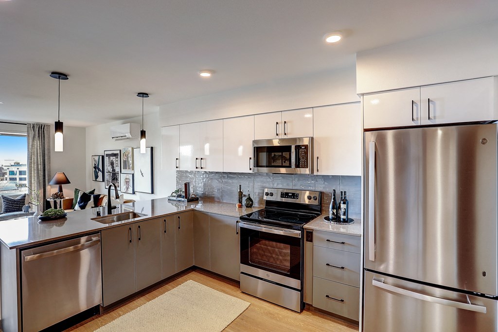 a kitchen with white cabinets and stainless steel appliances
