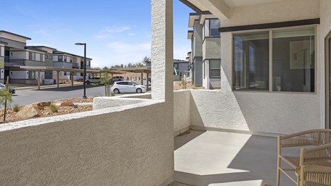A white car is parked in front of a building.