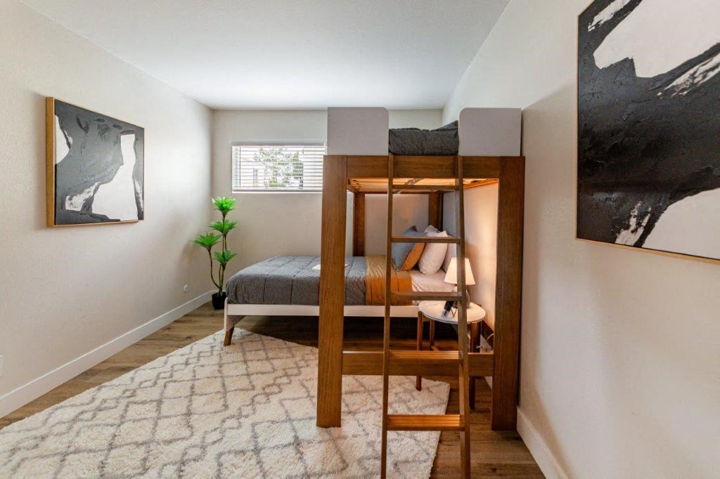a bunk bed in a bedroom with a ladder on top