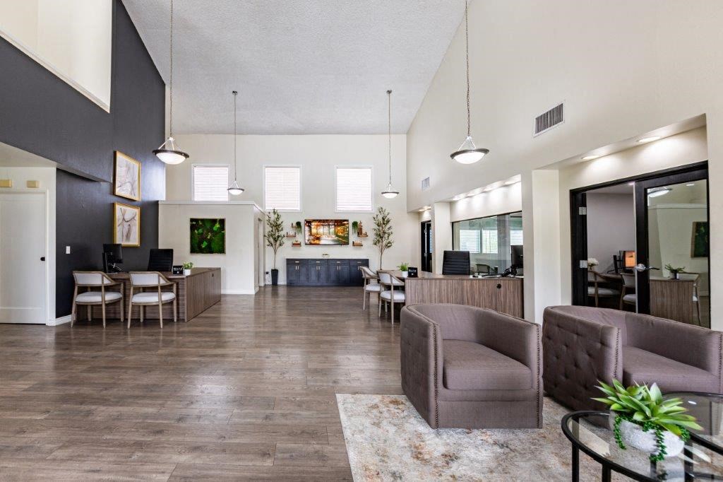 a large living room with a couch and a table