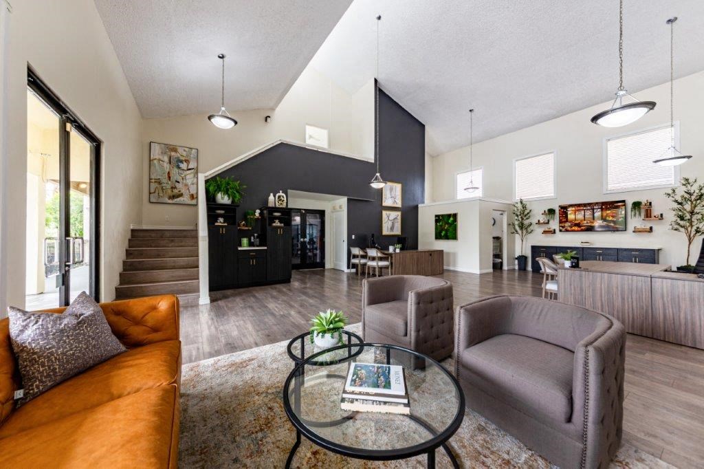 a living room with couches and chairs and a table