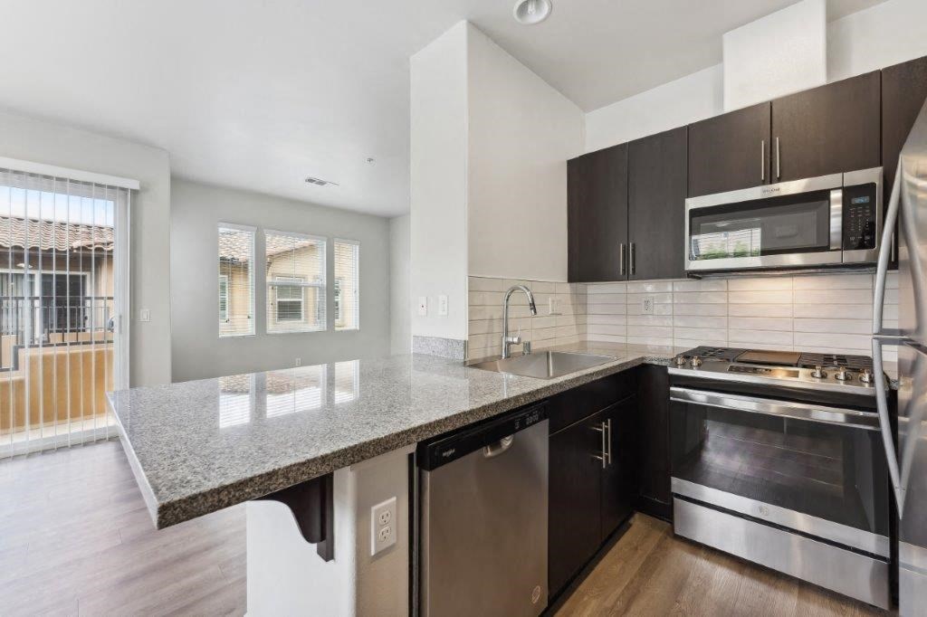 a kitchen with a granite counter top and stainless steel appliances