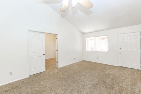 A room with white walls and a carpeted floor.