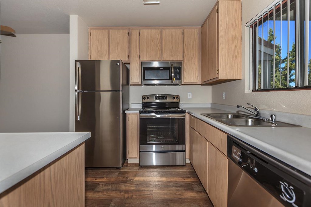 Sagecliff  kitchen with wooden cabinets and stainless steel appliances