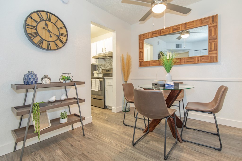 A dining room with a table and chairs.