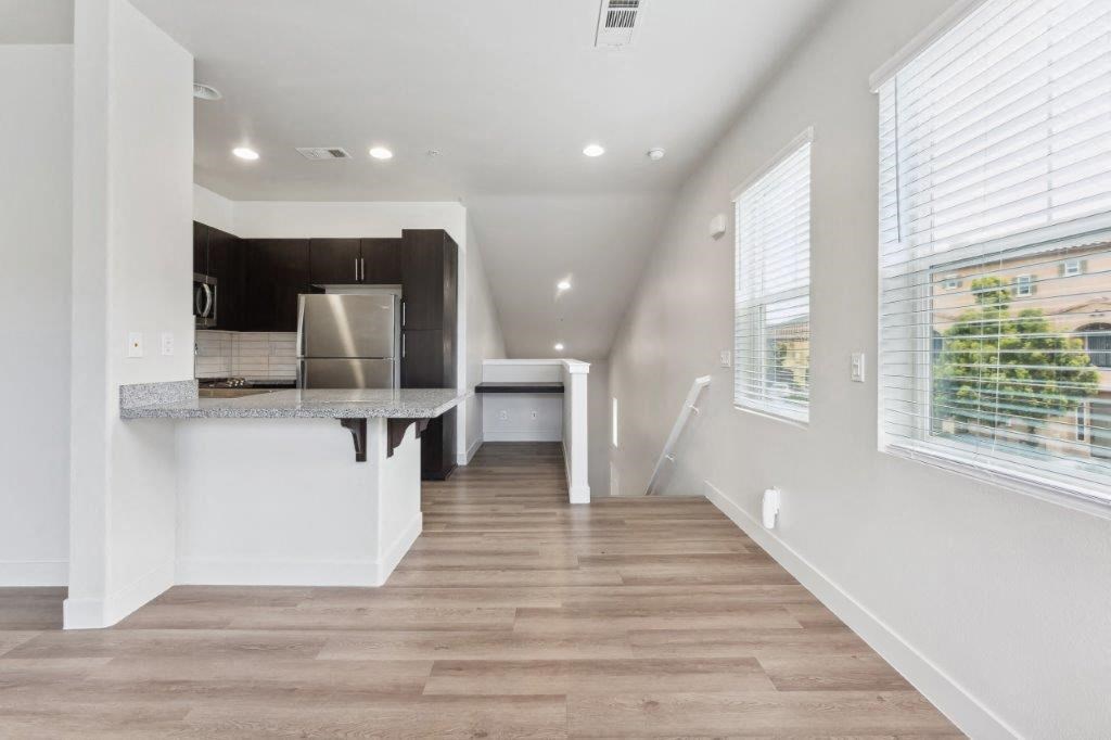 a room with a kitchen and a large window