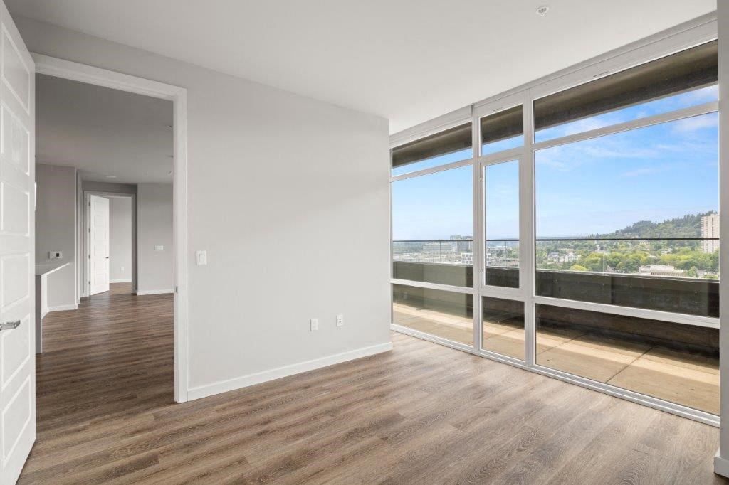 an empty living room with a view of a balcony