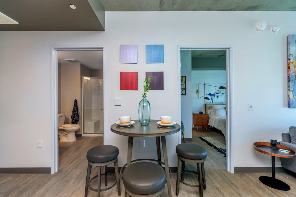 A dining area with a table and chairs.
