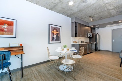 A dining area with a white table and chairs.