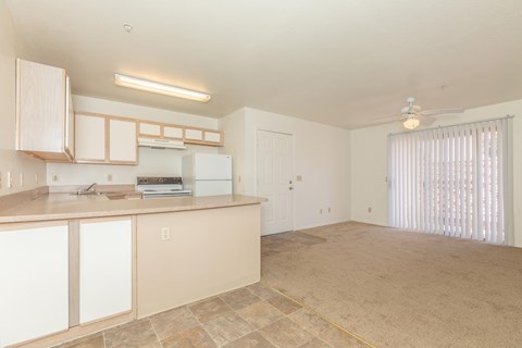 A kitchen with white cabinets and a counter top.