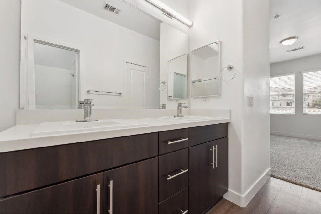 a bathroom with two sinks and a large mirror