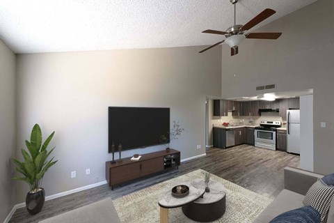 a living room with a flat screen tv and a kitchen