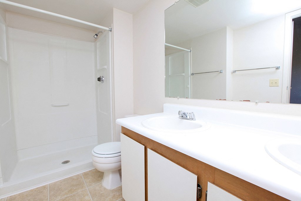 A white bathroom with a toilet and a sink.