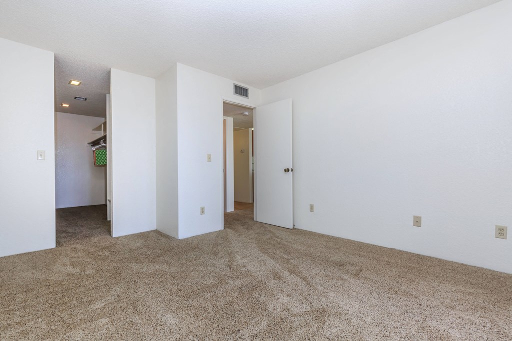 A room with white walls and carpeted floor.