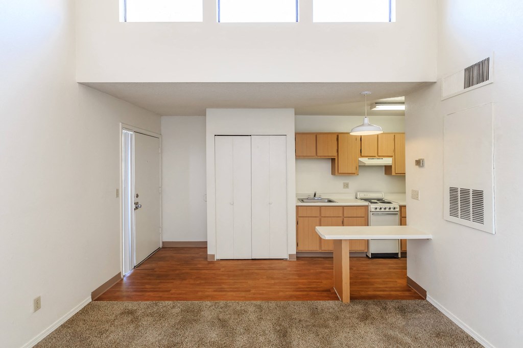 A kitchen with white cabinets and a wooden island.