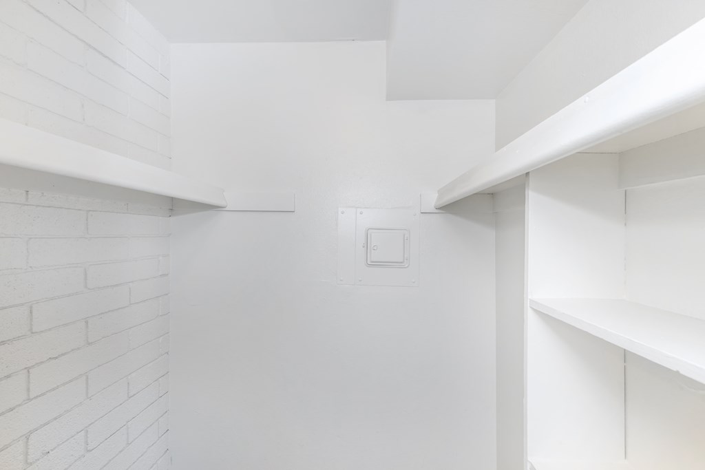 A white room with a white ceiling and white shelves.