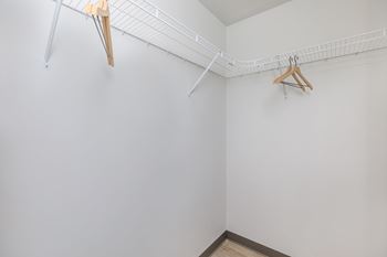 A white wall with a clothes hanger and a coat hanger.