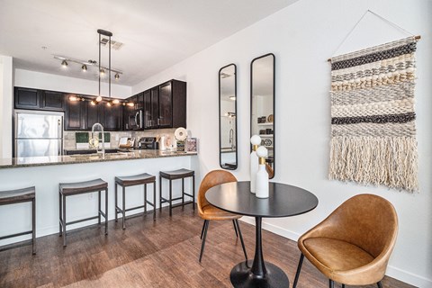 A kitchen with a bar and a chair.