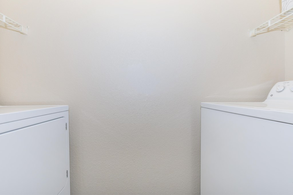 A white cabinet and a white sink in a room.
