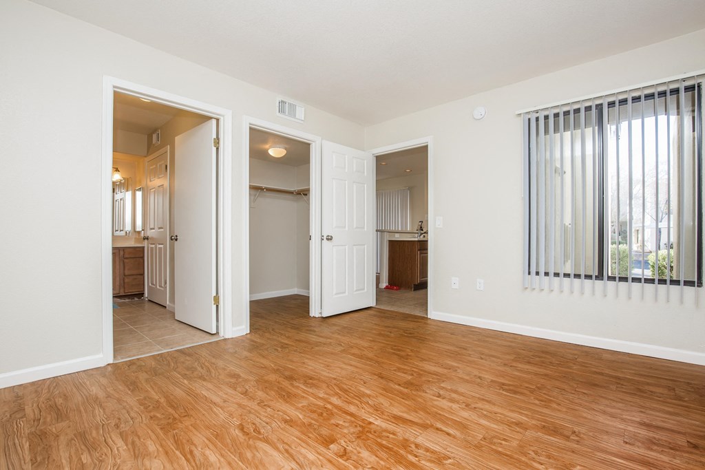 A room with wooden floors and white walls.